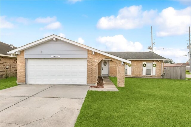 ranch-style house with a garage and a front lawn