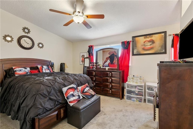 bedroom with light carpet, a textured ceiling, and ceiling fan