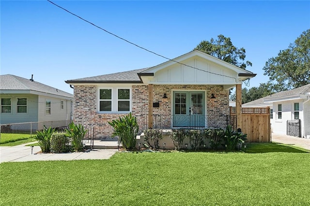 view of front facade featuring a front yard and french doors