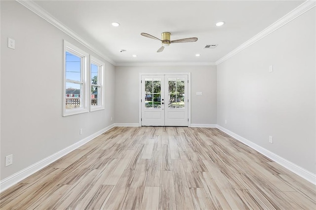 spare room featuring light hardwood / wood-style flooring, ornamental molding, and french doors