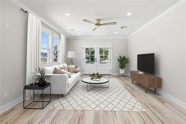 living room with crown molding, light hardwood / wood-style floors, french doors, and ceiling fan