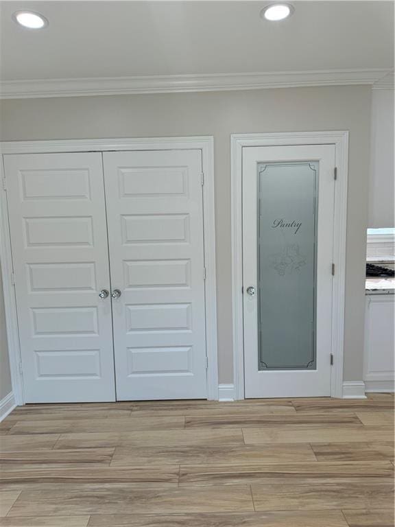 interior space featuring crown molding and hardwood / wood-style flooring