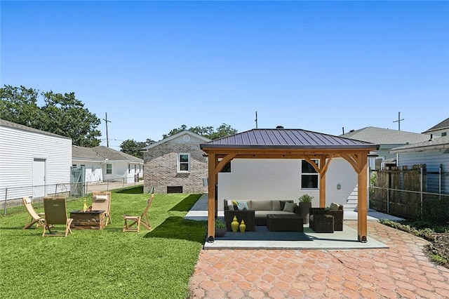 rear view of house with an outdoor living space, a gazebo, a yard, and a patio