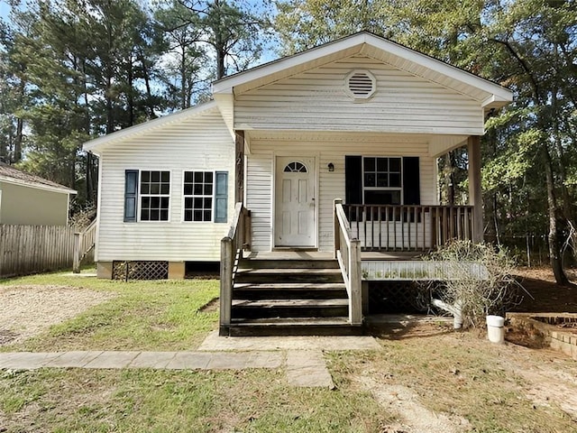 view of front of house with a porch and a front lawn