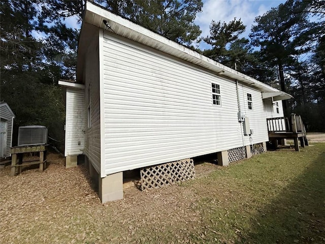 view of home's exterior featuring a yard and central AC