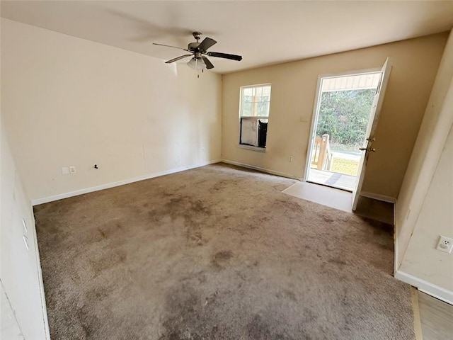 spare room with carpet floors and ceiling fan