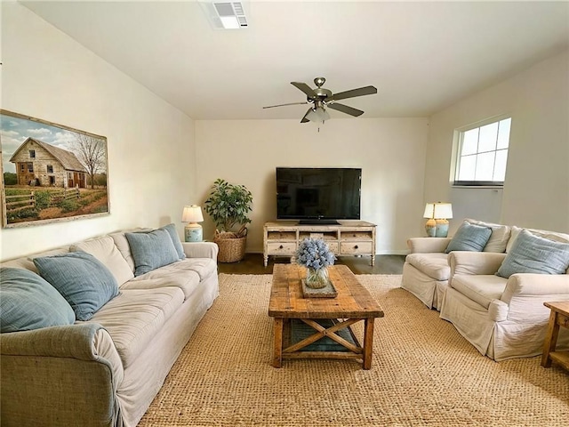 living room with ceiling fan and light wood-type flooring