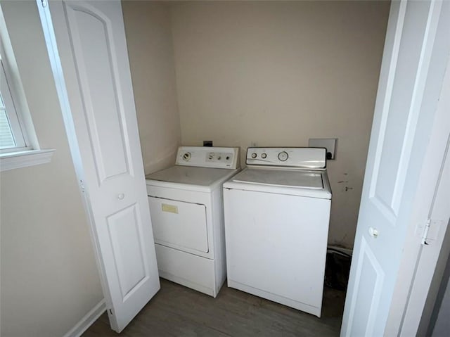 clothes washing area featuring separate washer and dryer and dark wood-type flooring