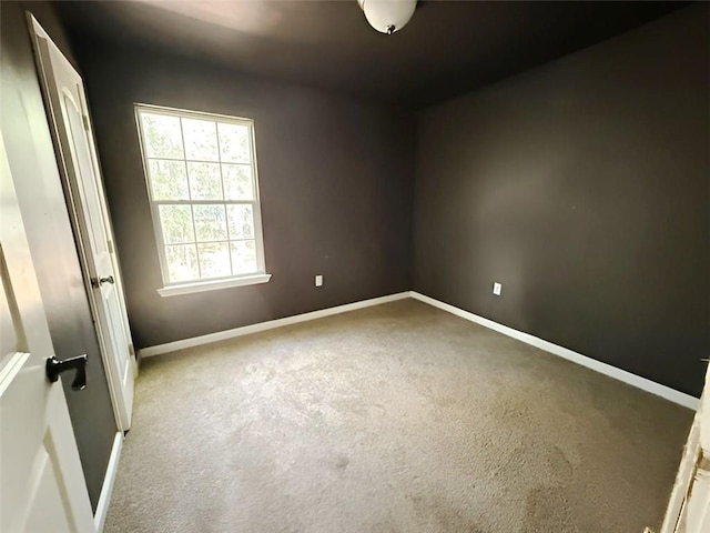 unfurnished room featuring light carpet