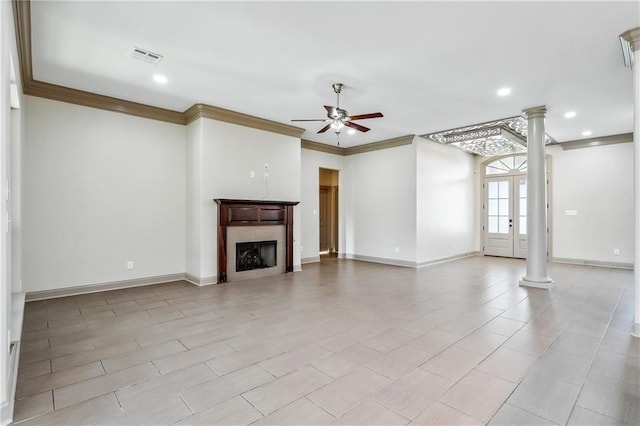 unfurnished living room with french doors, ornate columns, ceiling fan, and ornamental molding