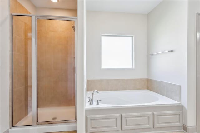 bathroom with shower with separate bathtub