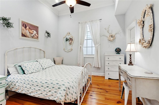 bedroom with crown molding, ceiling fan, and light hardwood / wood-style flooring