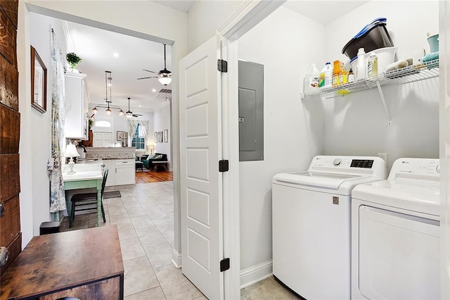 laundry room with light tile patterned floors, electric panel, independent washer and dryer, and ceiling fan