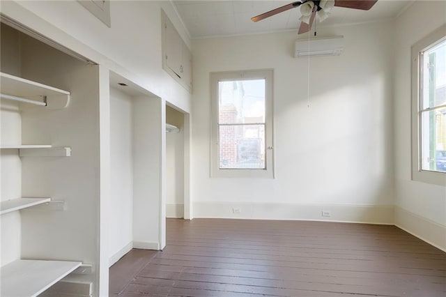 mudroom featuring a wall mounted AC, a wealth of natural light, dark wood-type flooring, and ornamental molding