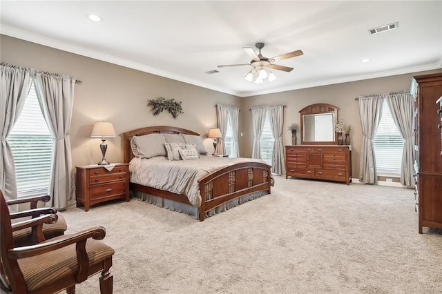 carpeted bedroom with ceiling fan and crown molding