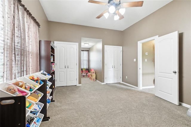 interior space with light carpet and ceiling fan