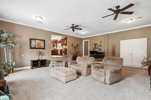 carpeted living room featuring ceiling fan and ornamental molding