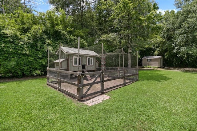 back of house with a storage shed and a yard