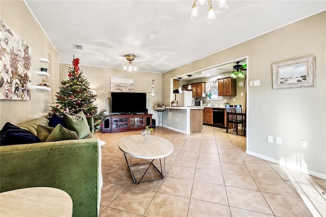 tiled living room featuring an inviting chandelier