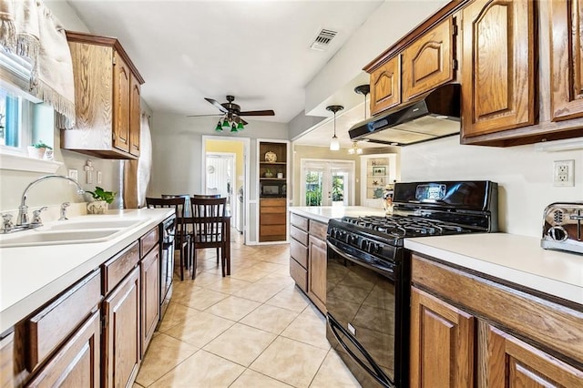 kitchen with black range with gas cooktop, ceiling fan, sink, light tile patterned floors, and decorative light fixtures