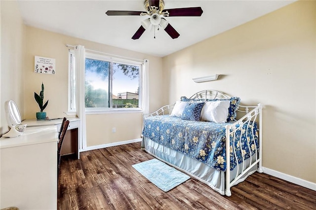 bedroom with ceiling fan and dark hardwood / wood-style floors