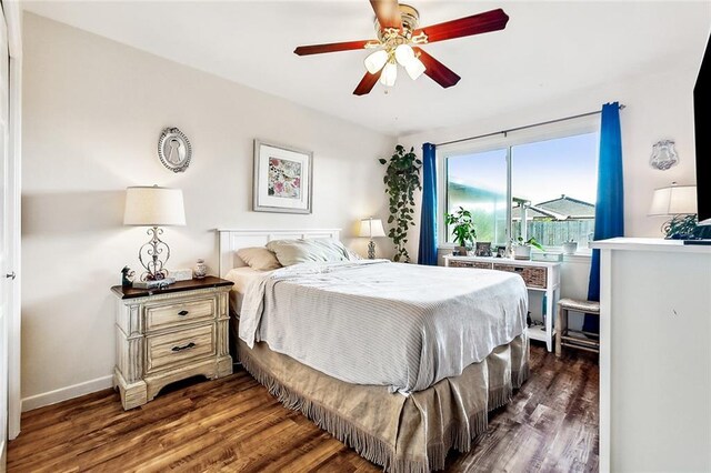 bedroom with ceiling fan and dark wood-type flooring