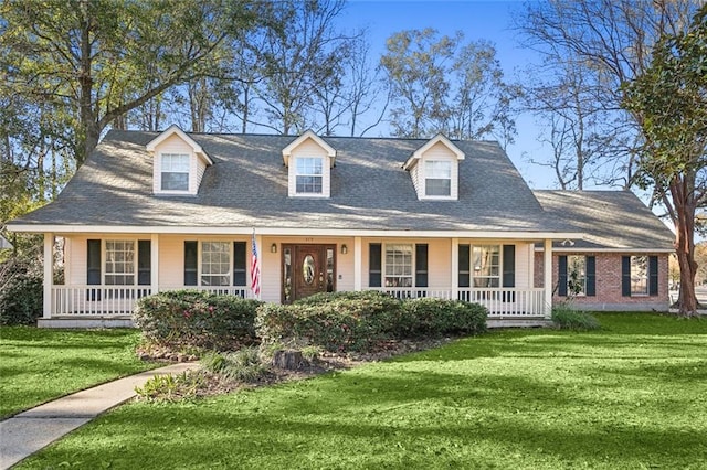 new england style home featuring a porch and a front yard