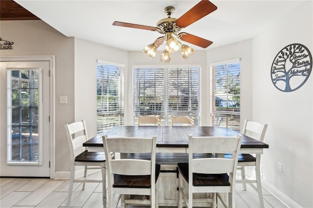 dining room featuring light tile patterned floors, plenty of natural light, and ceiling fan