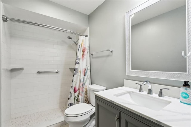 bathroom with vanity, toilet, and walk in shower