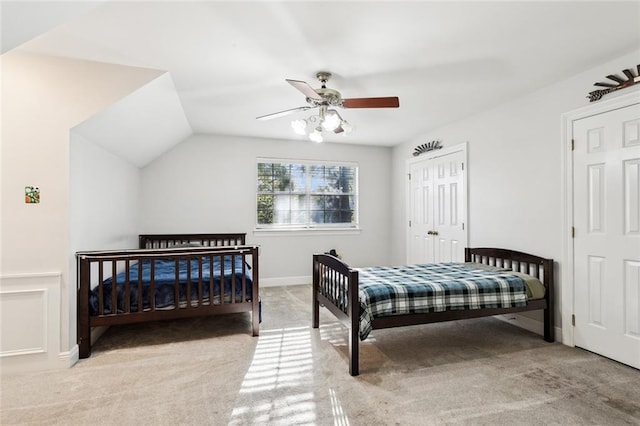 bedroom with a closet, light colored carpet, ceiling fan, and lofted ceiling