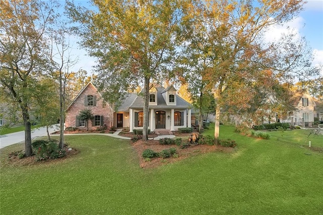 cape cod-style house with a front yard