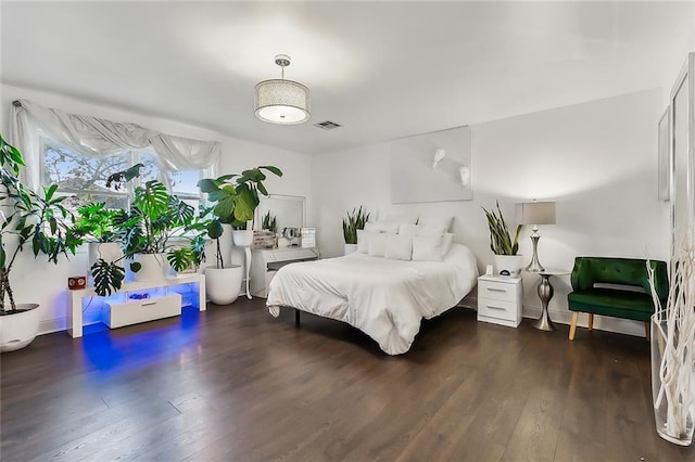 bedroom featuring dark hardwood / wood-style flooring