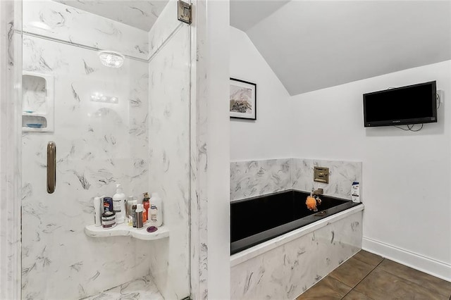 bathroom with tile patterned flooring and vaulted ceiling