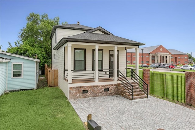 view of front of home with a porch and a front yard