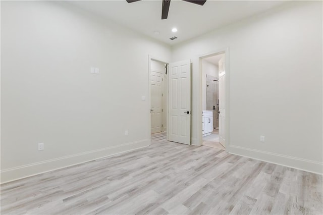 unfurnished bedroom featuring ensuite bathroom, ceiling fan, and light hardwood / wood-style flooring