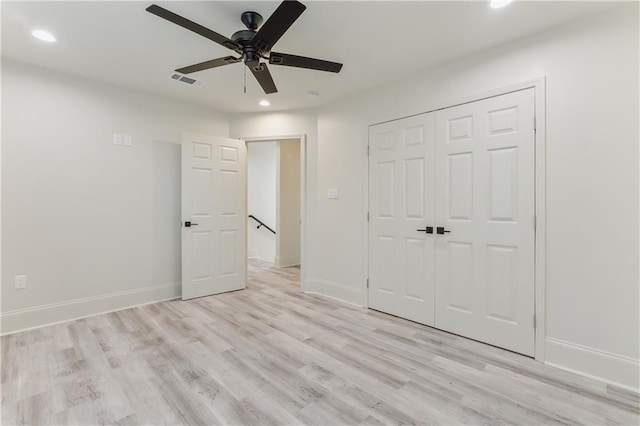 unfurnished bedroom with light hardwood / wood-style floors, ceiling fan, and a closet