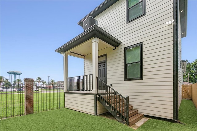 property entrance with central AC and a lawn