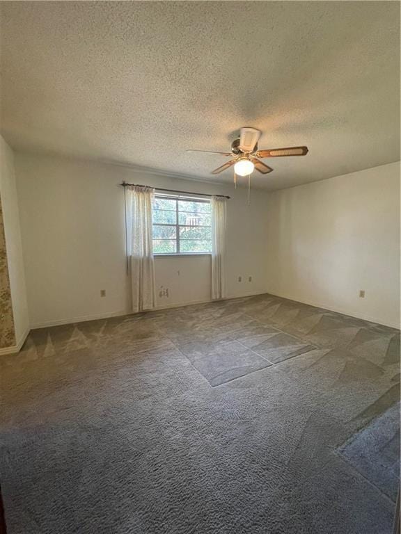 carpeted empty room featuring a textured ceiling and ceiling fan