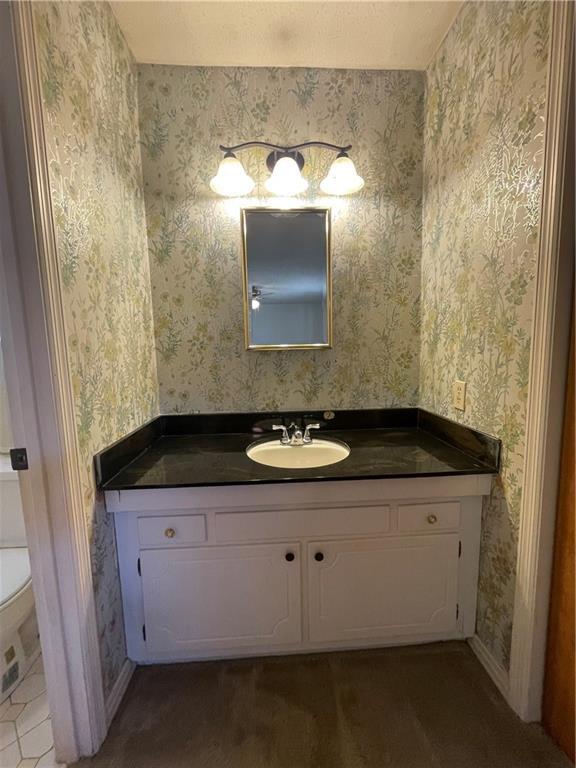 bathroom featuring vanity and toilet