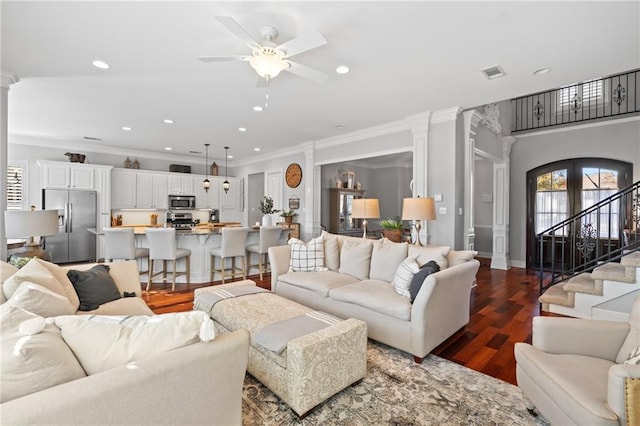 living room with ceiling fan, wood-type flooring, ornamental molding, and french doors