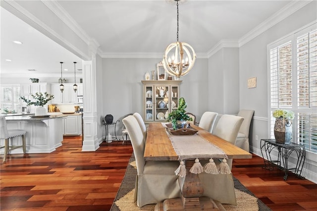 dining area with ornamental molding, dark wood-type flooring, and a notable chandelier