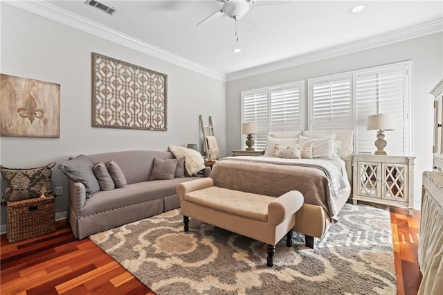 bedroom with ceiling fan, dark hardwood / wood-style floors, and ornamental molding