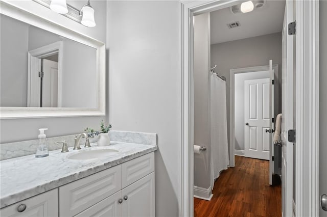 bathroom featuring vanity and wood-type flooring