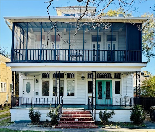 view of front of house with covered porch and a balcony