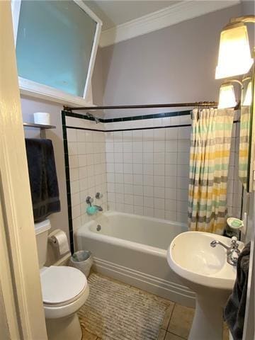 full bathroom featuring shower / tub combo, tile patterned floors, ornamental molding, sink, and toilet