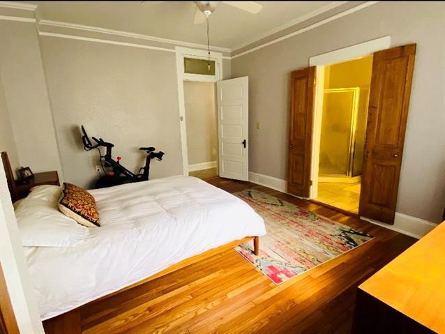 bedroom featuring hardwood / wood-style floors and ceiling fan