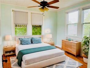 bedroom featuring hardwood / wood-style floors, ceiling fan, and ornamental molding