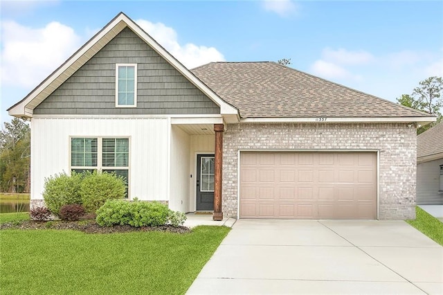 view of front of property featuring a front lawn and a garage