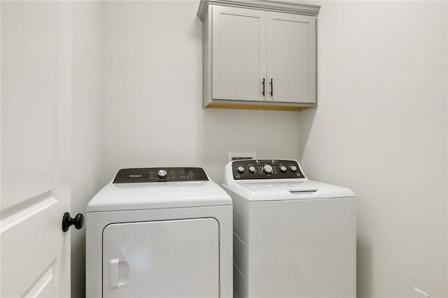 laundry room with cabinets and washer and dryer