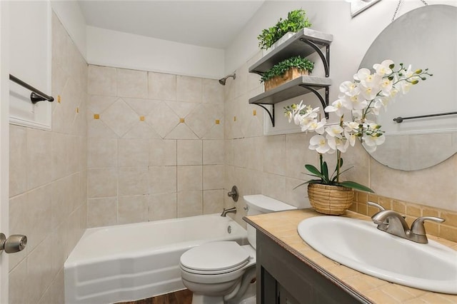 full bathroom with tile walls, backsplash, vanity, toilet, and tiled shower / bath